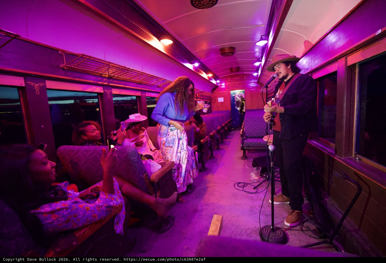 Intimate Live Music Performance on Purple-Lit Train Car