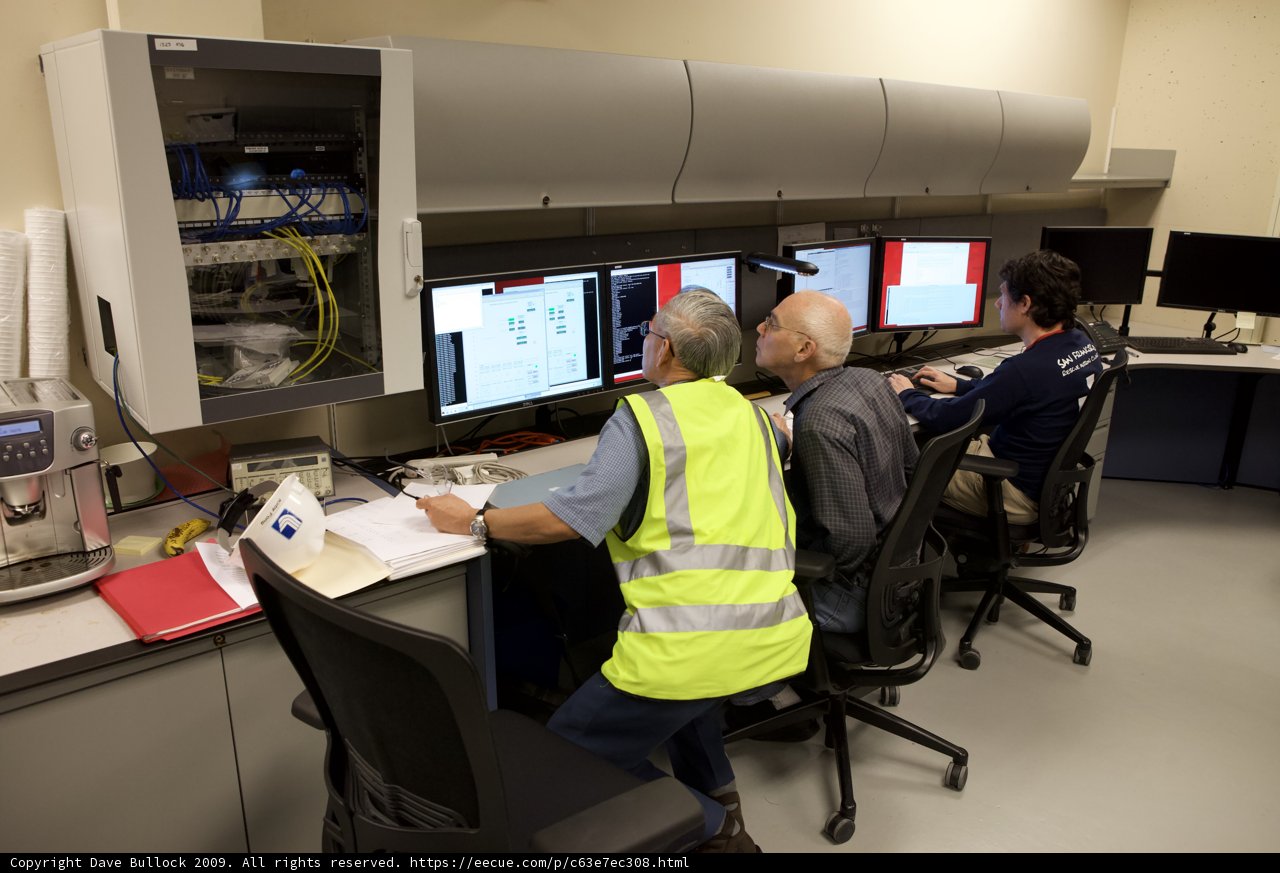Three Men in a Technology-Driven Workspace