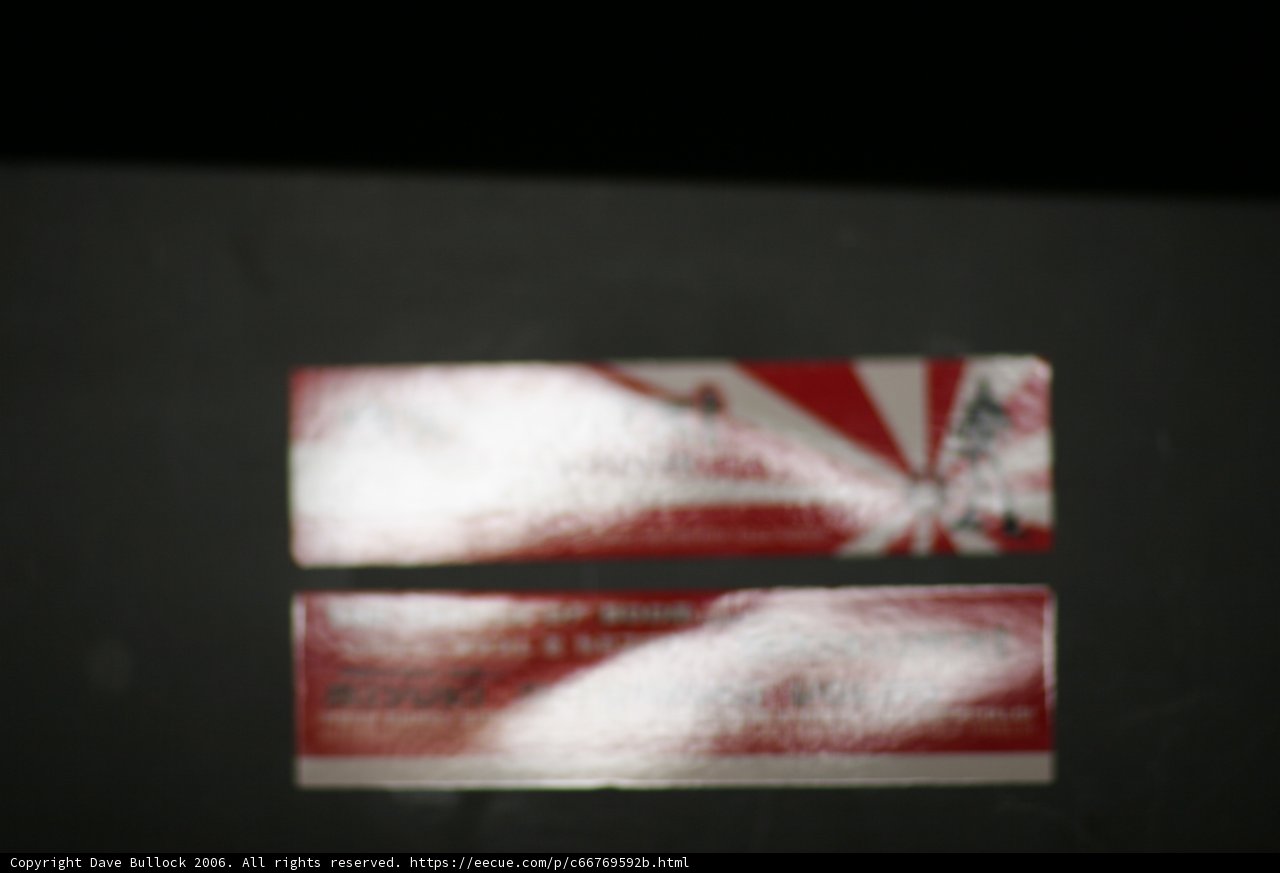 Red and White Sticker on Black Surface