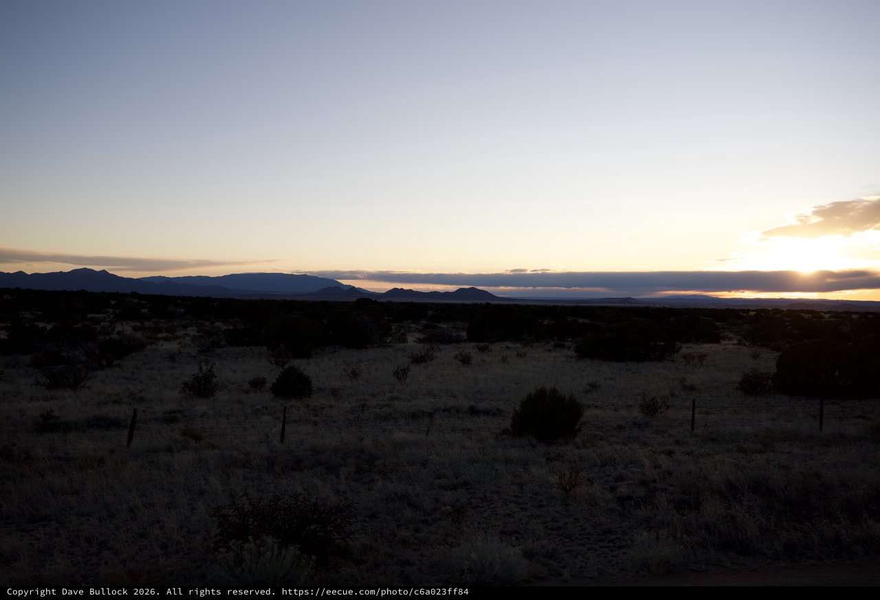 Desert Sunset Over Distant Mountain Range