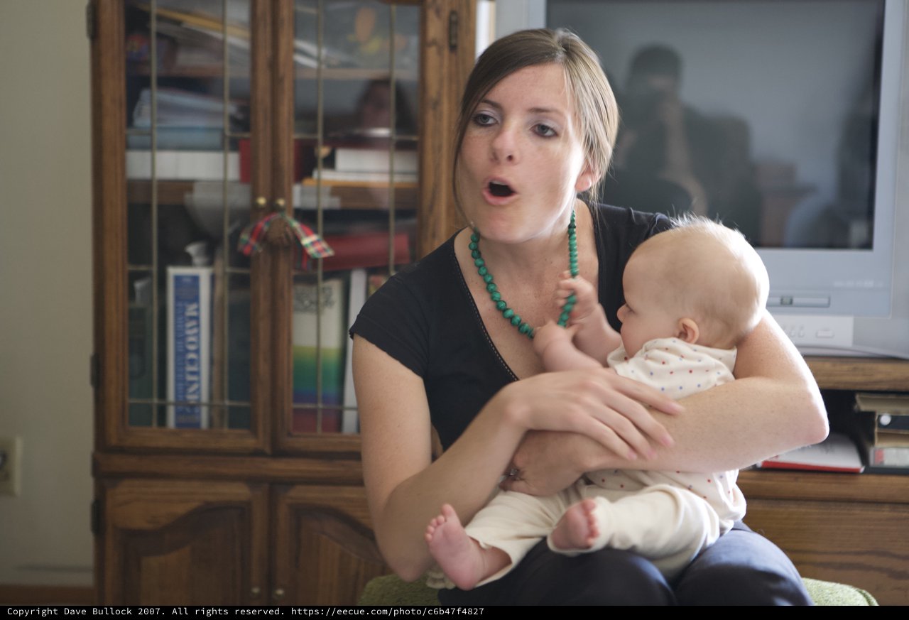 Young Mother Singing to Her Infant at Home