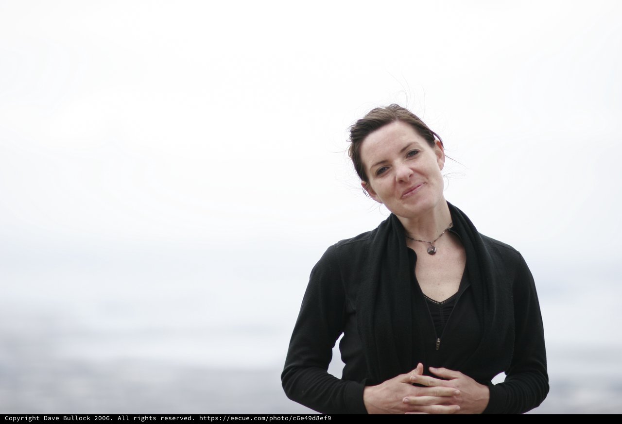 Windswept Woman Smiling by the Bay