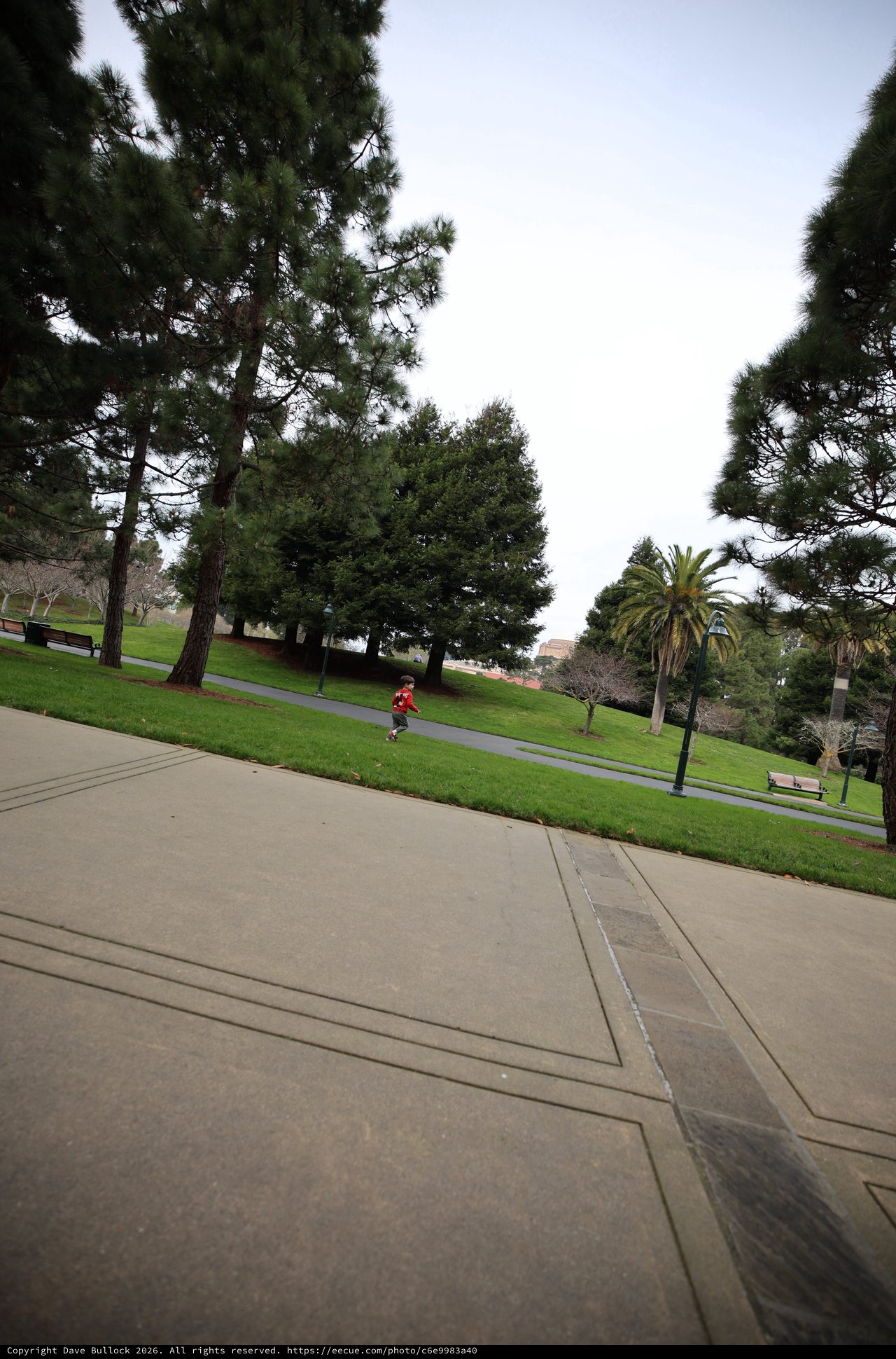 Child Running Through Park on Overcast Day