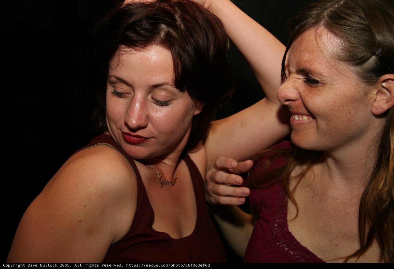 Two Women Dancing Together at Nightclub Party