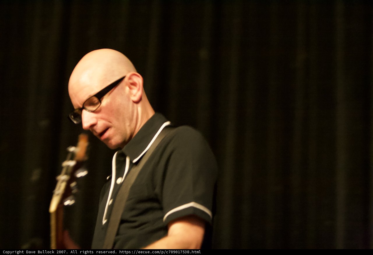 Bald man rocks out on guitar at Bad Religion concert
