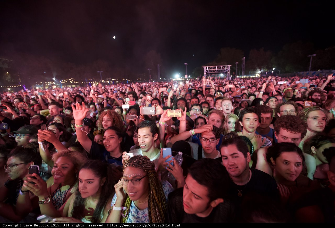 FYF Fest Wide Crowd Woman Blonde Braids Glasses Floral Shirt Blue iPhone Moon Cyan Blue Lighting