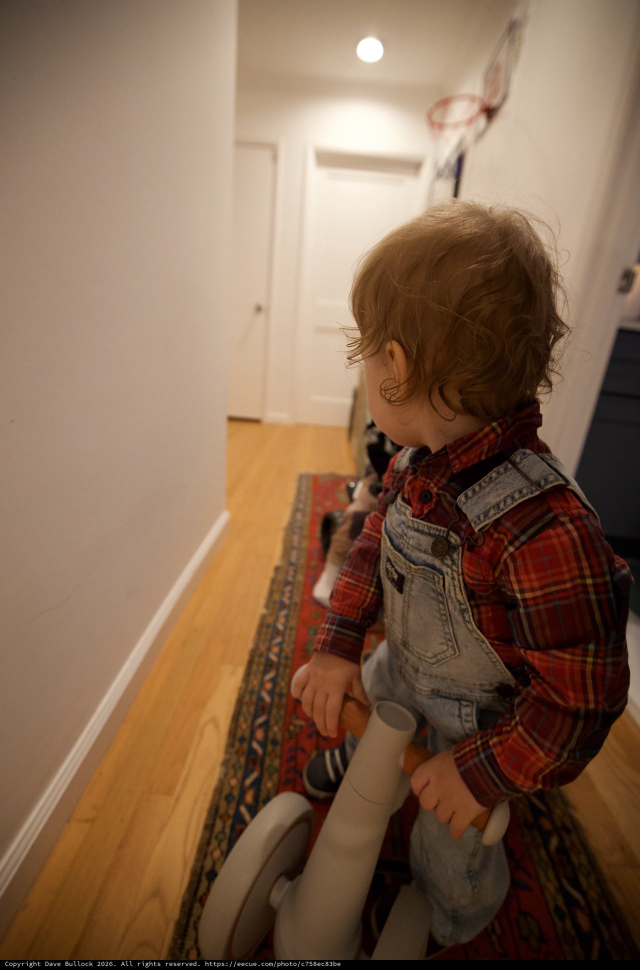 Toddler on Toy Horse in Hallway