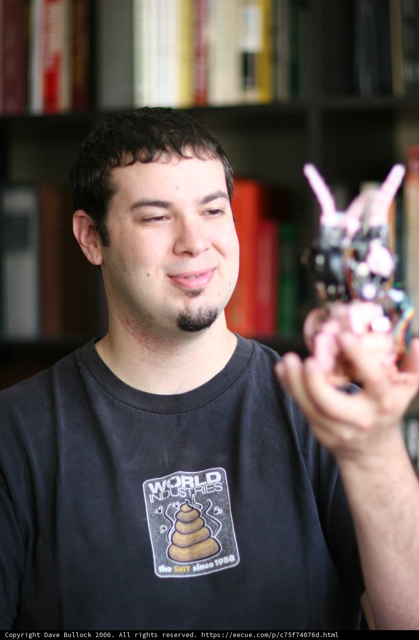 Man and Toy on Bookshelf