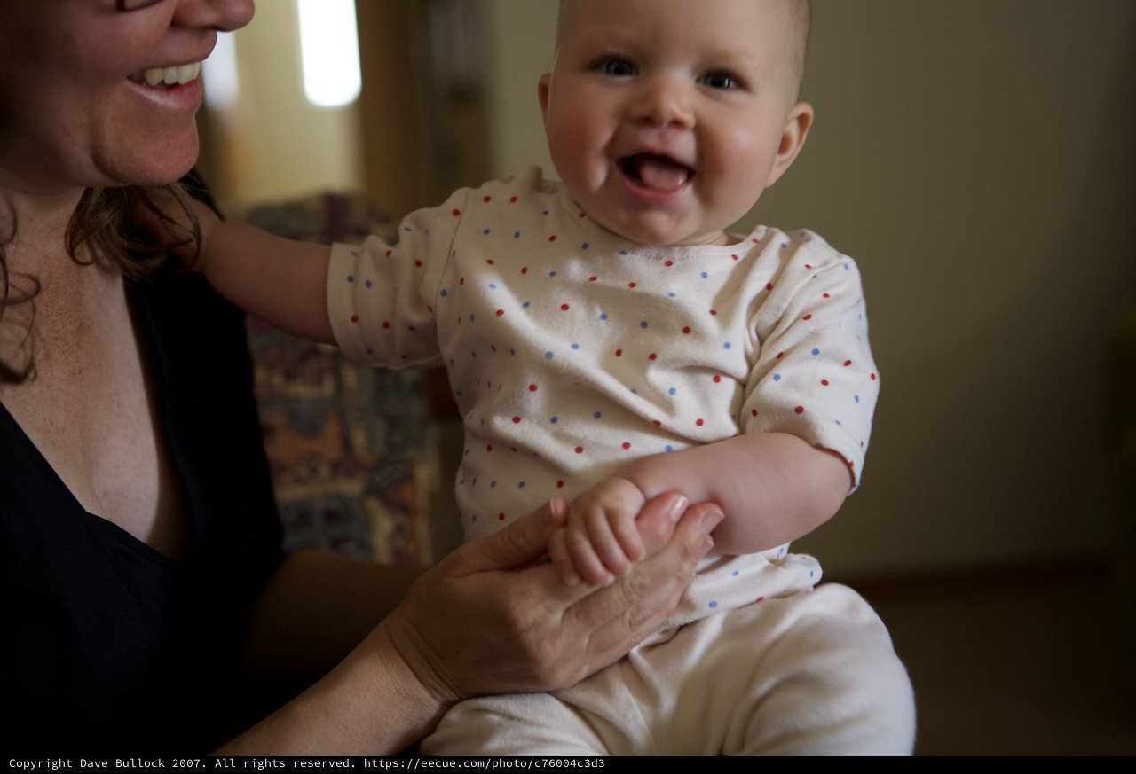 Joyful Baby Laughing in Mother's Arms