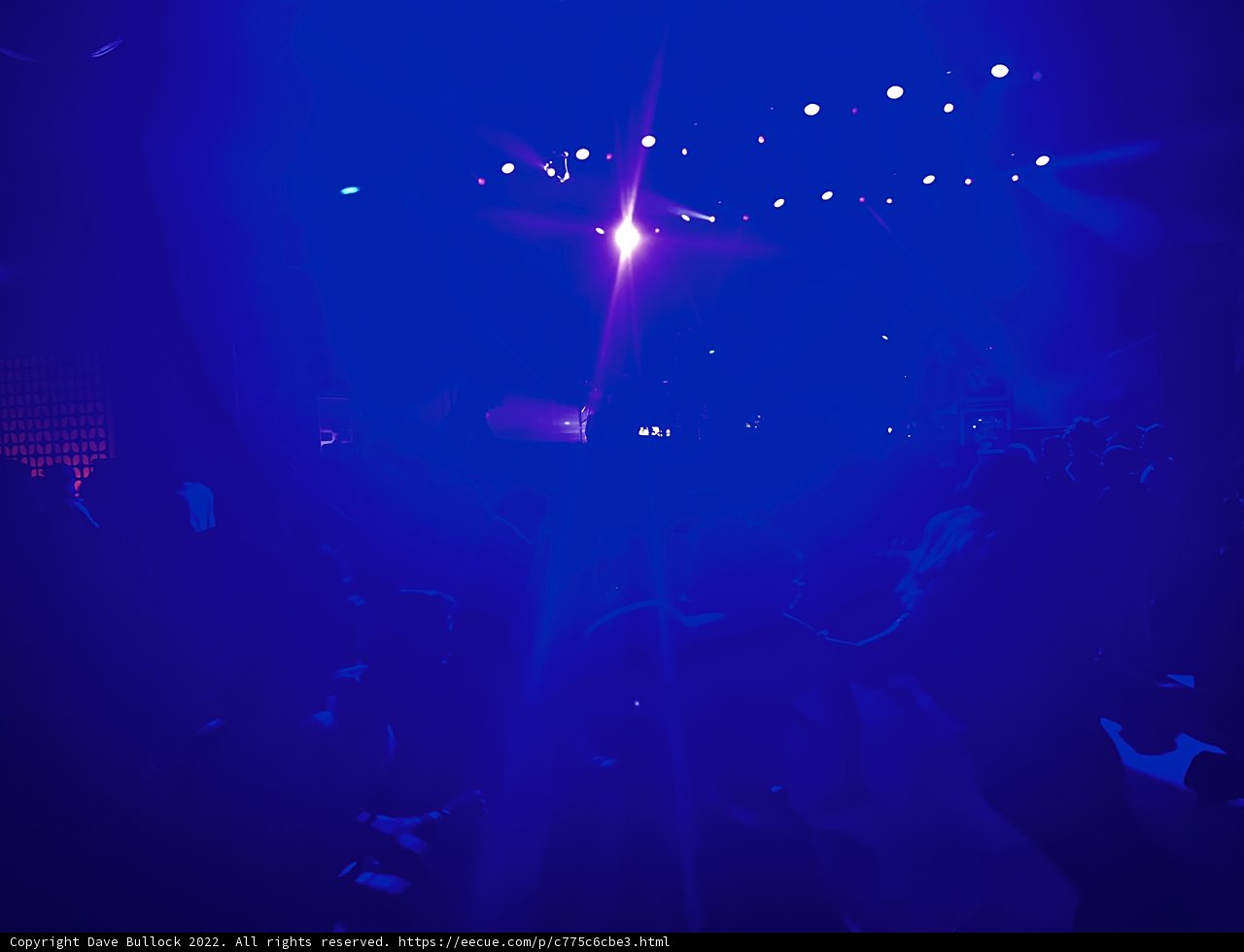 Blue Spotlights Shining on the Nightclub Crowd