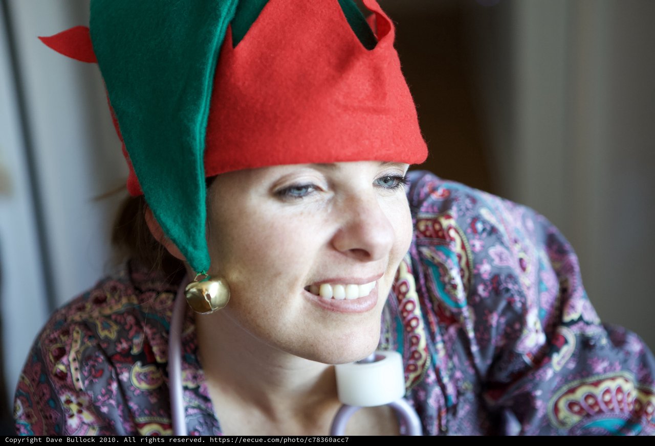 Joyful Woman in Christmas Elf Hat Smiling Warmly