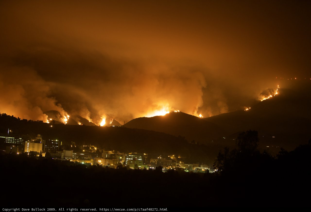 Flames Engulf Hills Above City Skyline