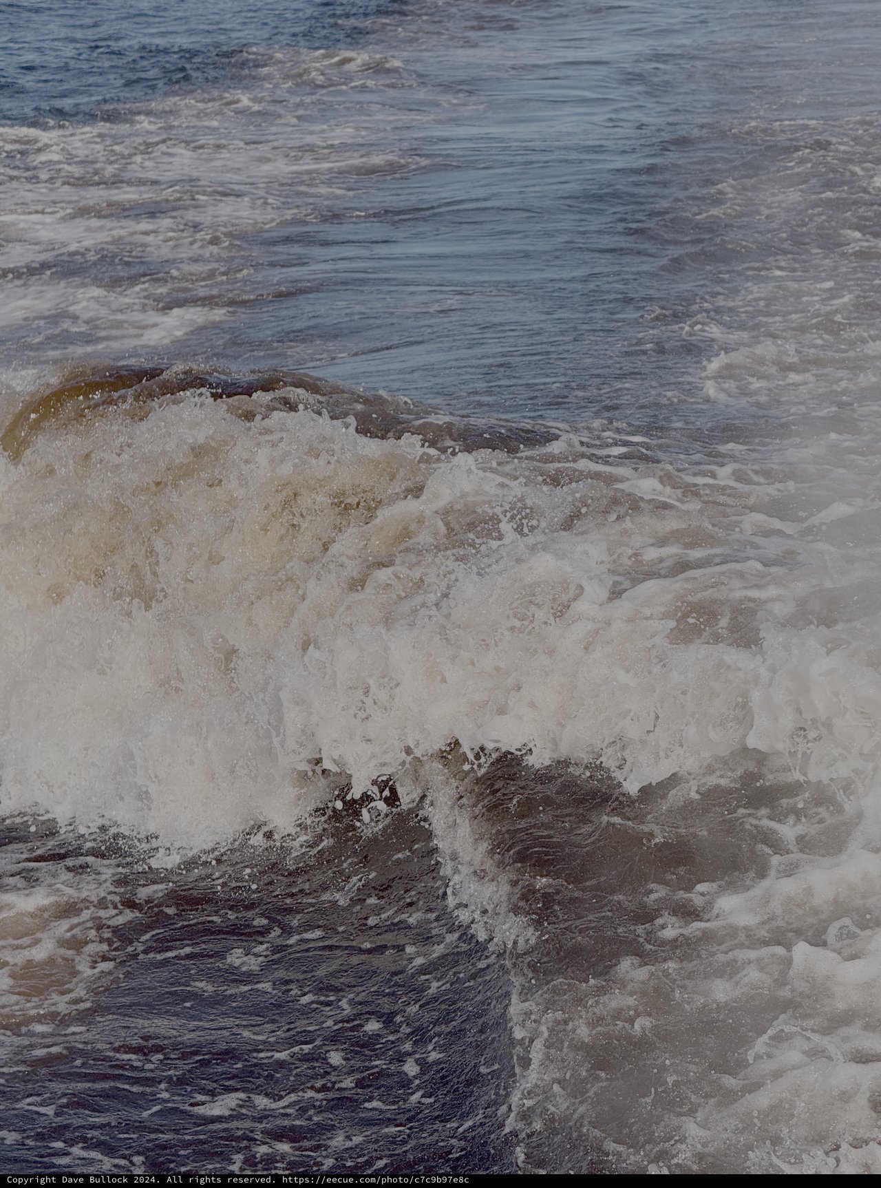 Powerful Ocean Waves Crashing Against Rocky Shore