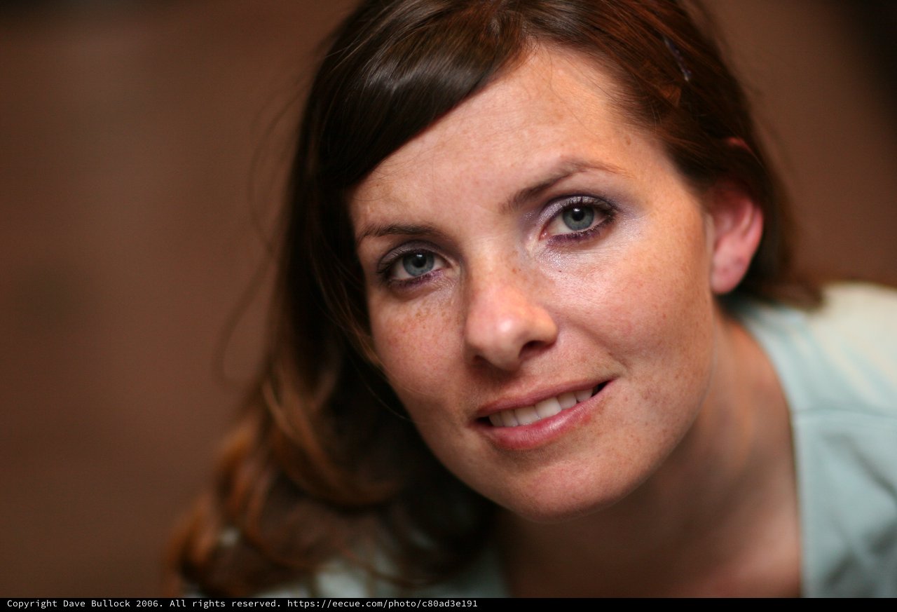Freckled Woman with Blue Eyes Smiling Warmly