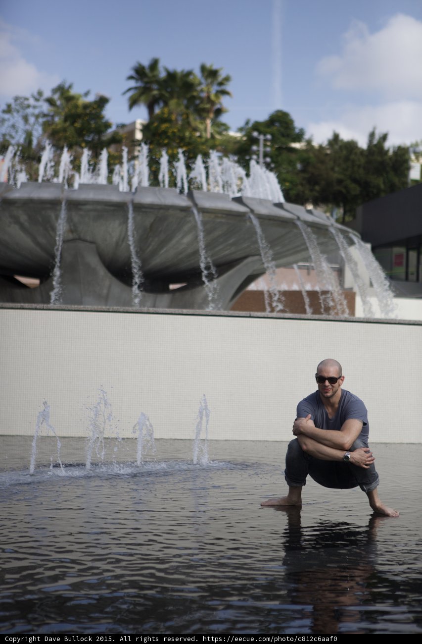 Thoughtful Crouch at Fountain