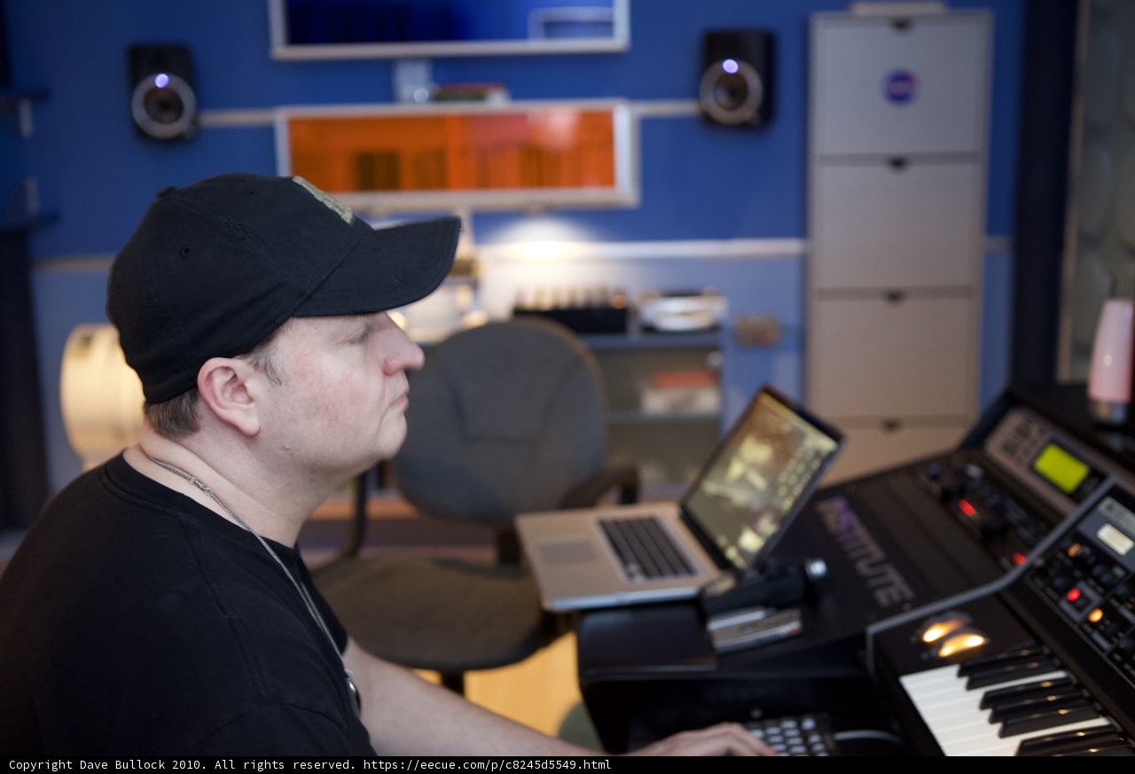 Man in Black Hat Working on Computer