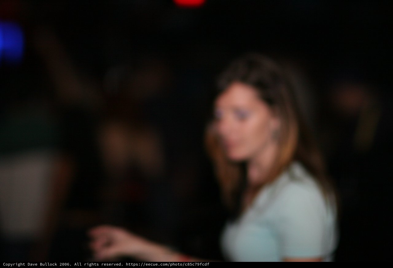 Woman Glancing Back in Dimly Lit Nightclub