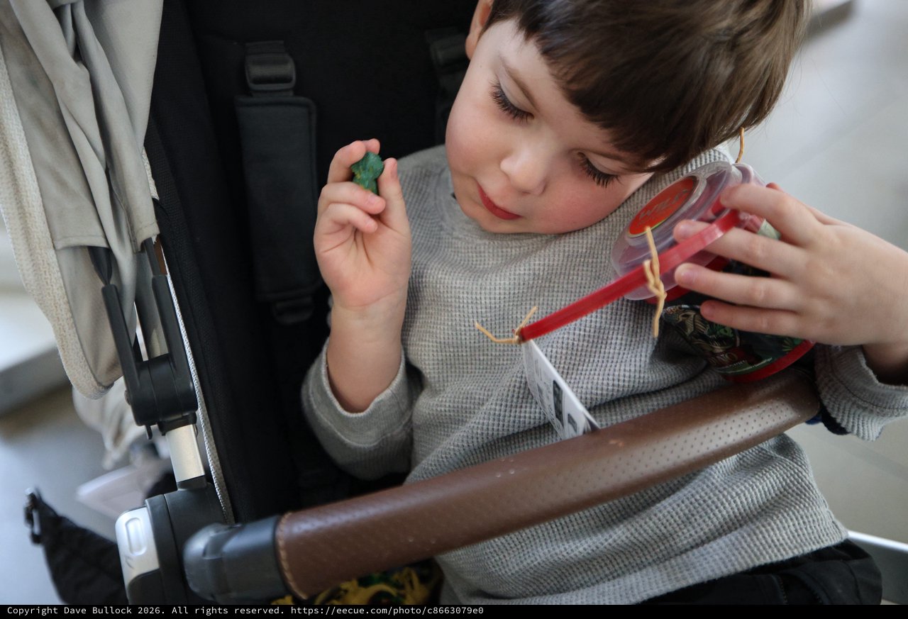 Child with Gummy Candy Container on Airplane