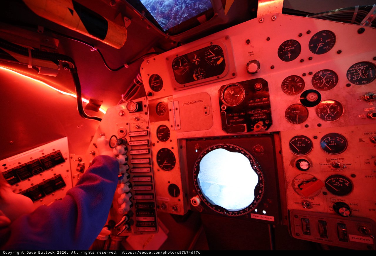 Inside a Vintage Spacecraft Control Module Under Red Lighting