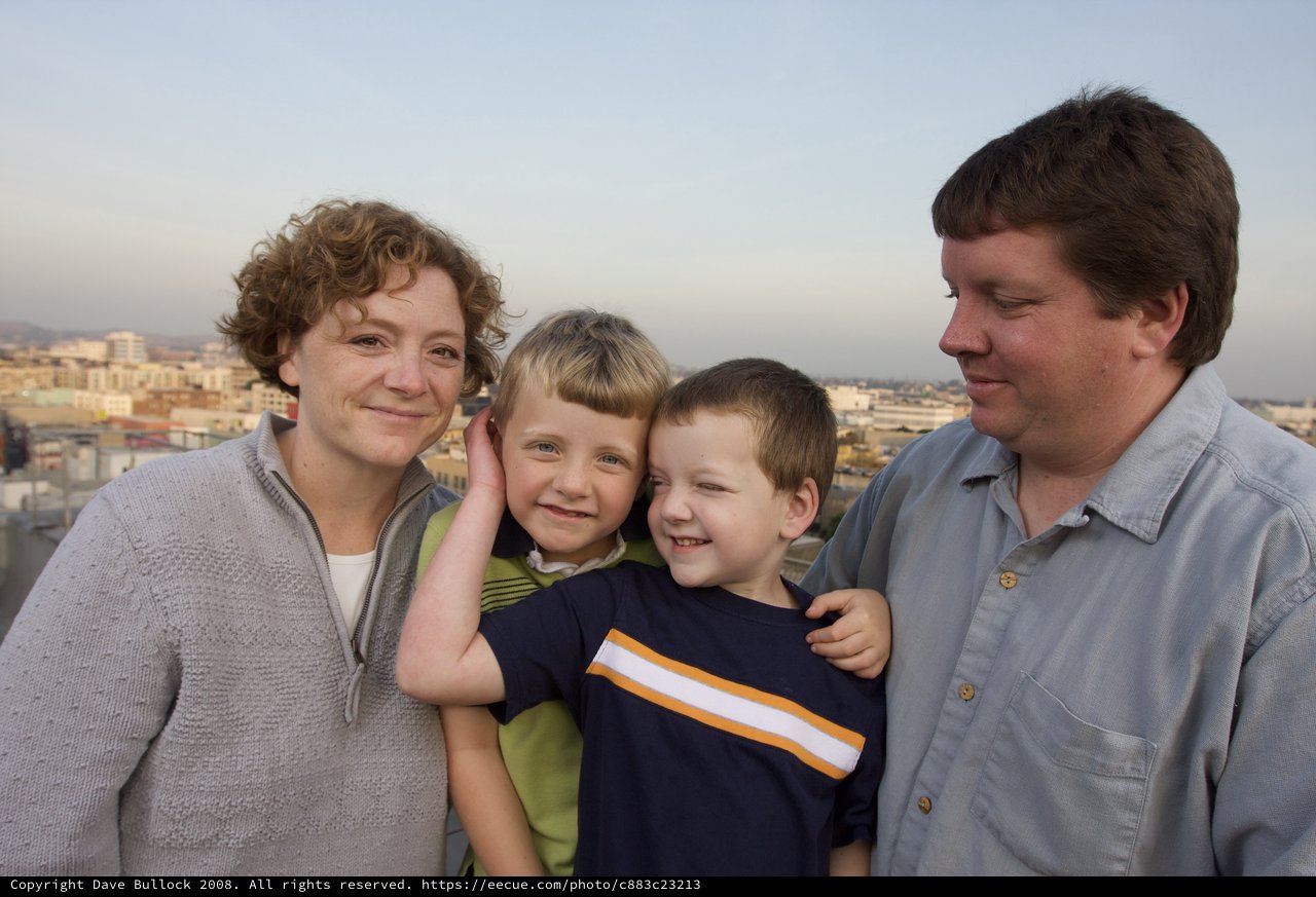 Family Portrait on City Rooftop at Dusk