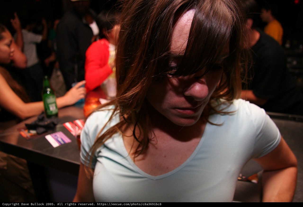 Young Woman Lost in Thought at Nightclub Bar