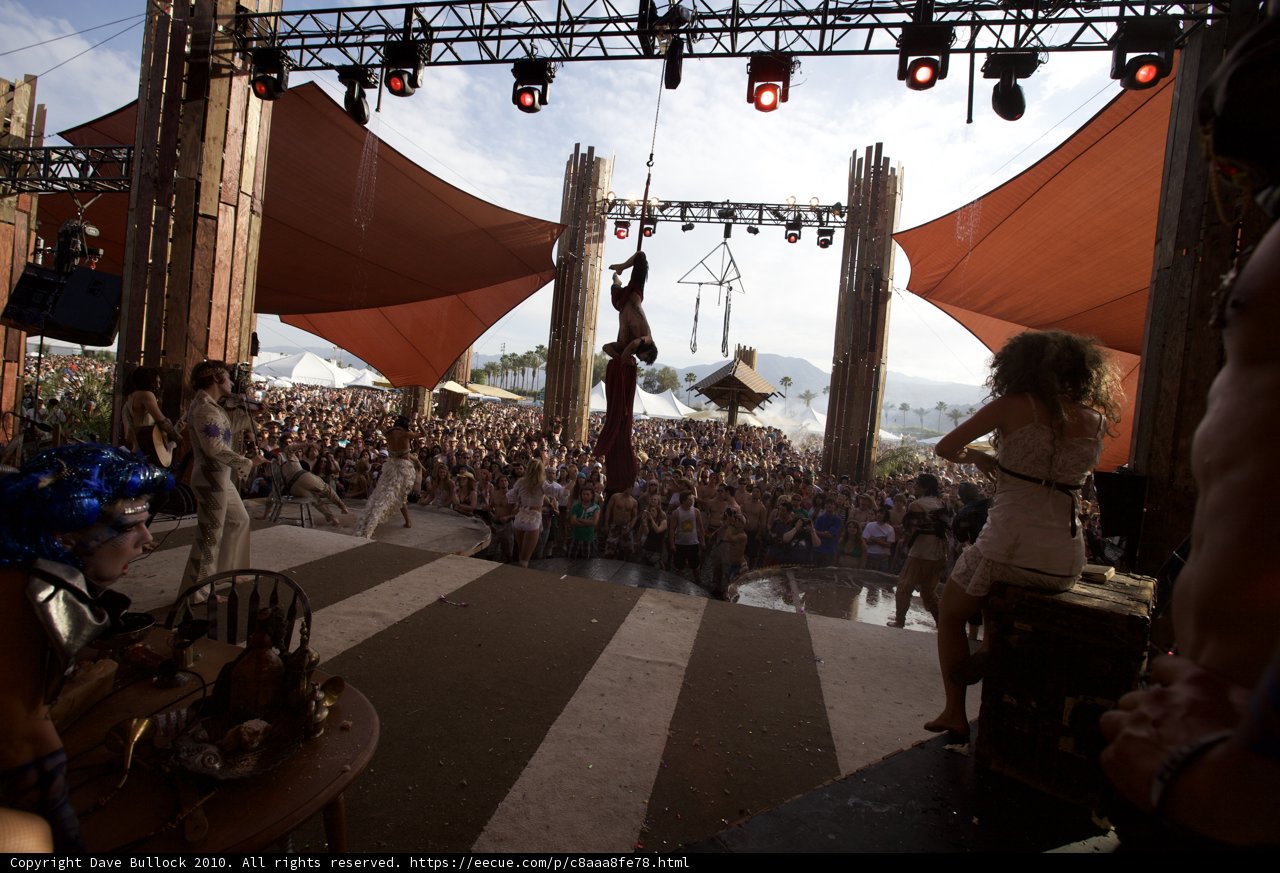 Man on Stage with Bikini-Clad Woman at Coachella Concert