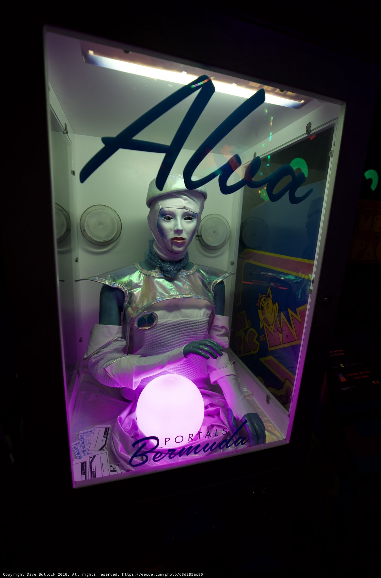 Futuristic Alien Fortune Teller Display in Retro Arcade Booth