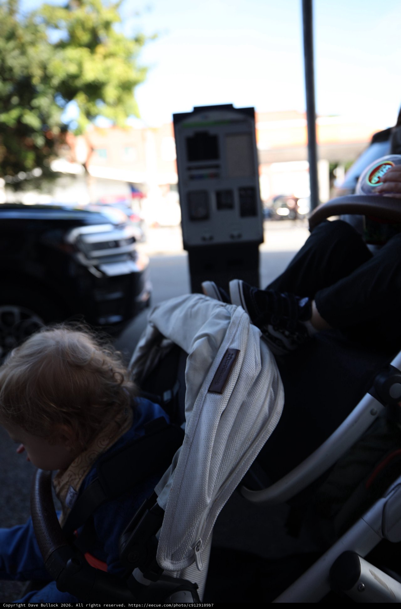 Child in Stroller on Sunny Street