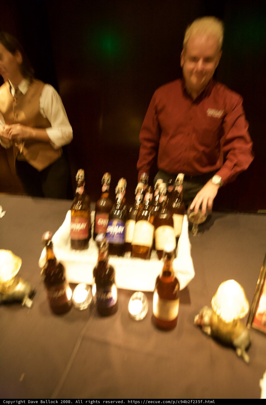 Man Behind Bar Table with Bottles of Alcohol