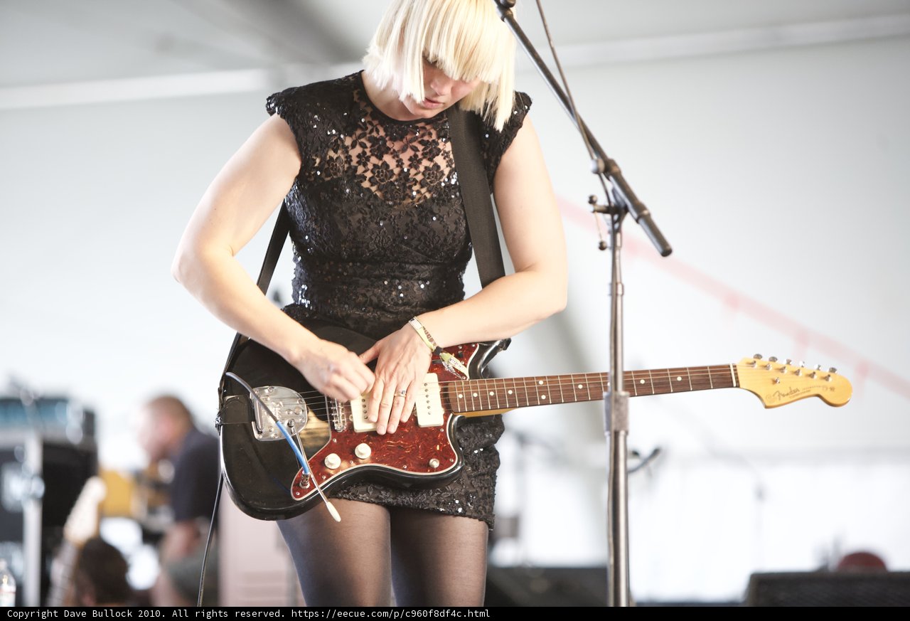 Rocking the Crowds with Black Dress and a Guitar