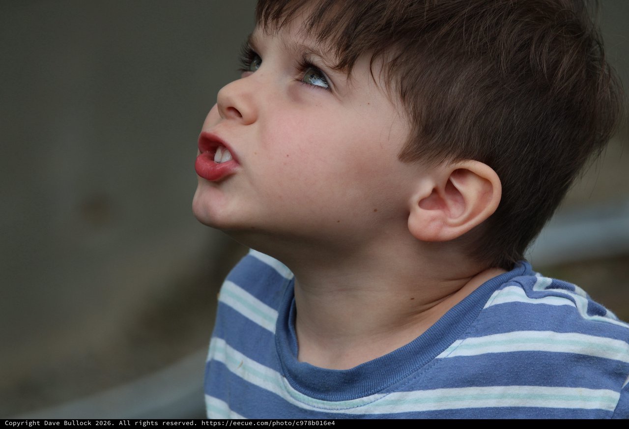 Young Child Looking Upward with Playful Expression