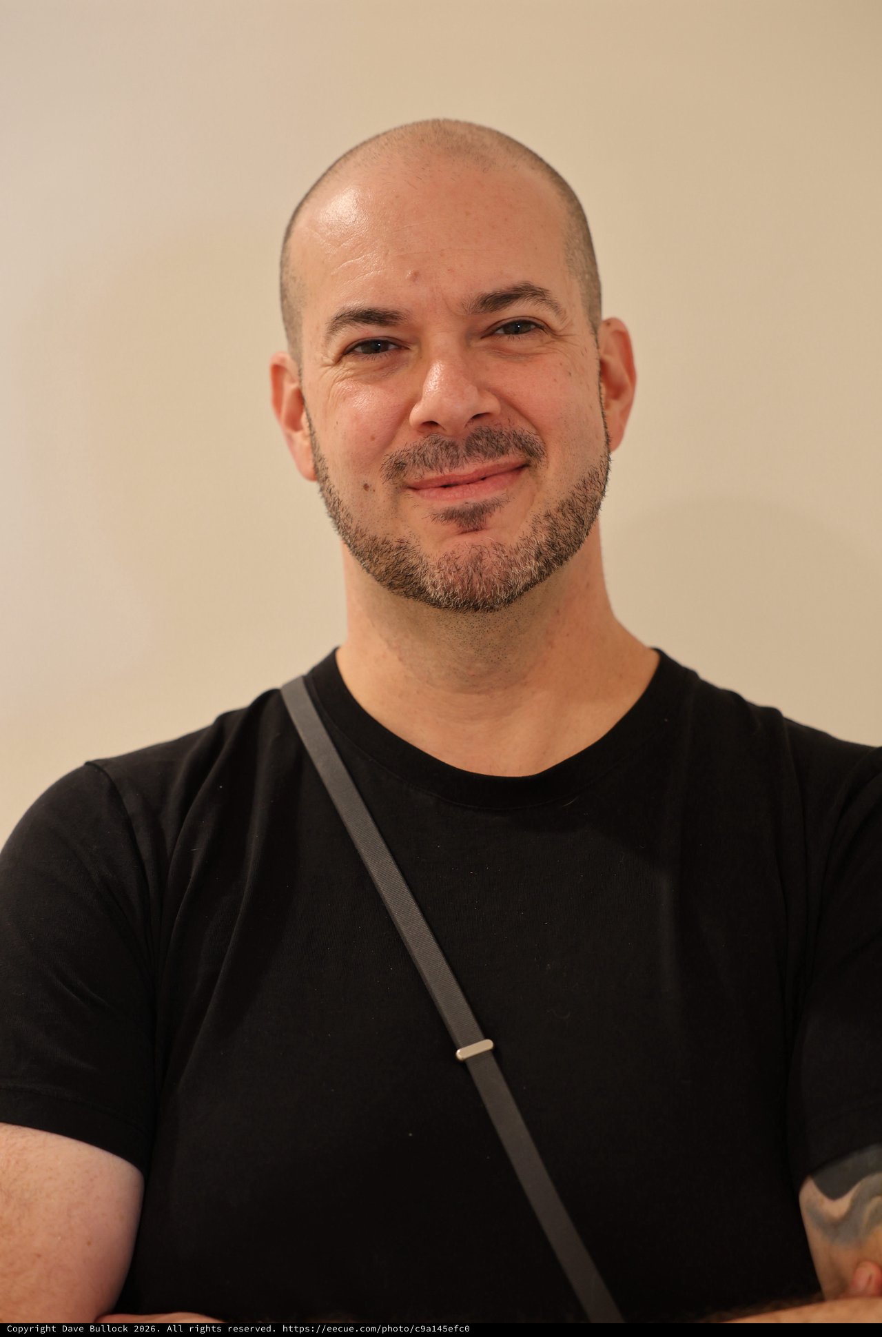 Professional Portrait of Smiling Bald Man in Black