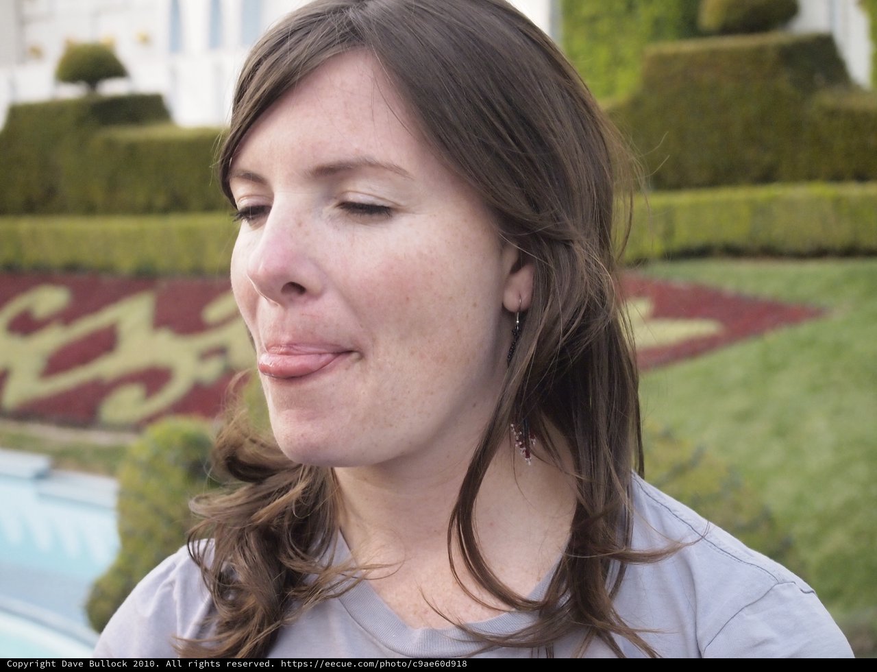 Woman Making a Playful Face in Formal Garden