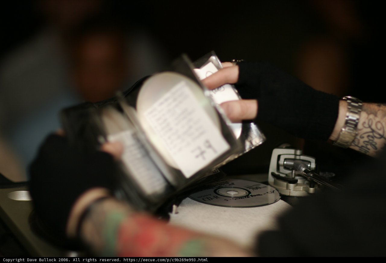 Tattooed Man Holds CD