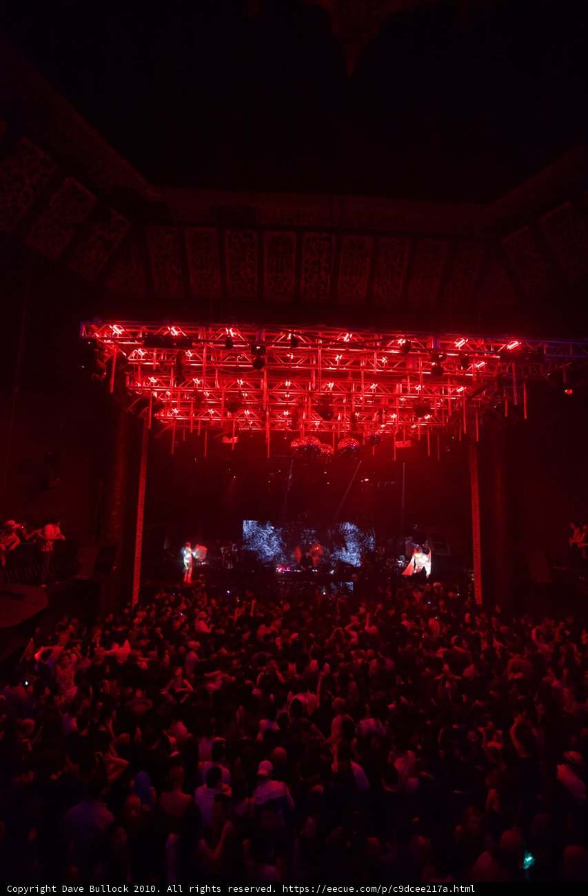 Red Spotlight on a Rock Concert Crowd