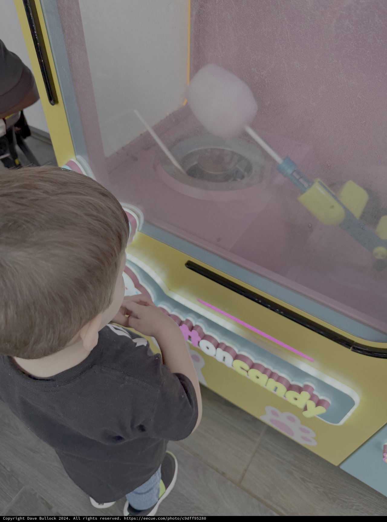 Child Playing with Cotton Candy Machine