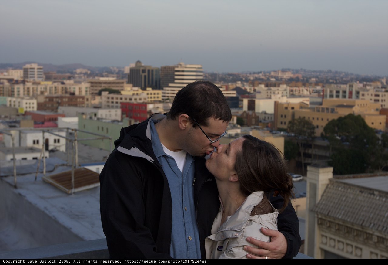 Rooftop Kiss at Dusk Over the City
