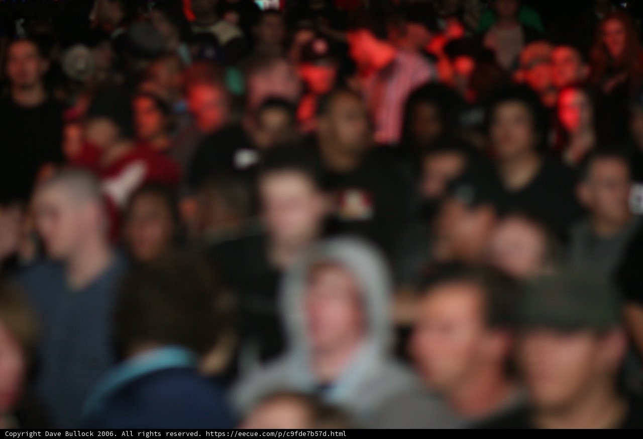 Vibrant Red Lights Illuminate Energetic Concert-Goers