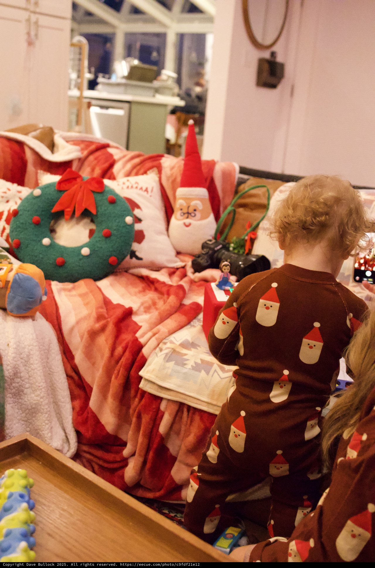 Toddler's Christmas Morning with Festive Decorations and Toys
