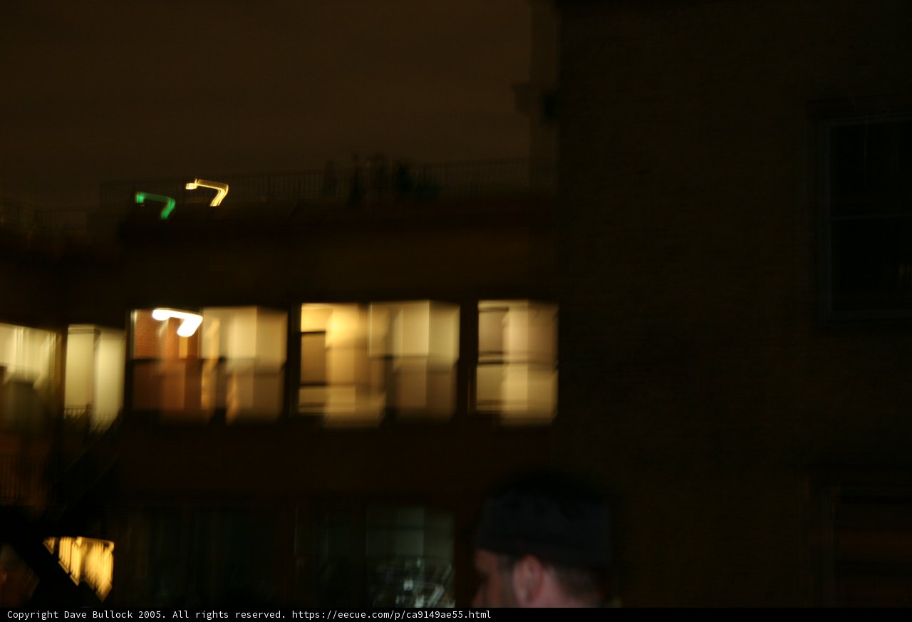 Man standing in front of an illuminated building
