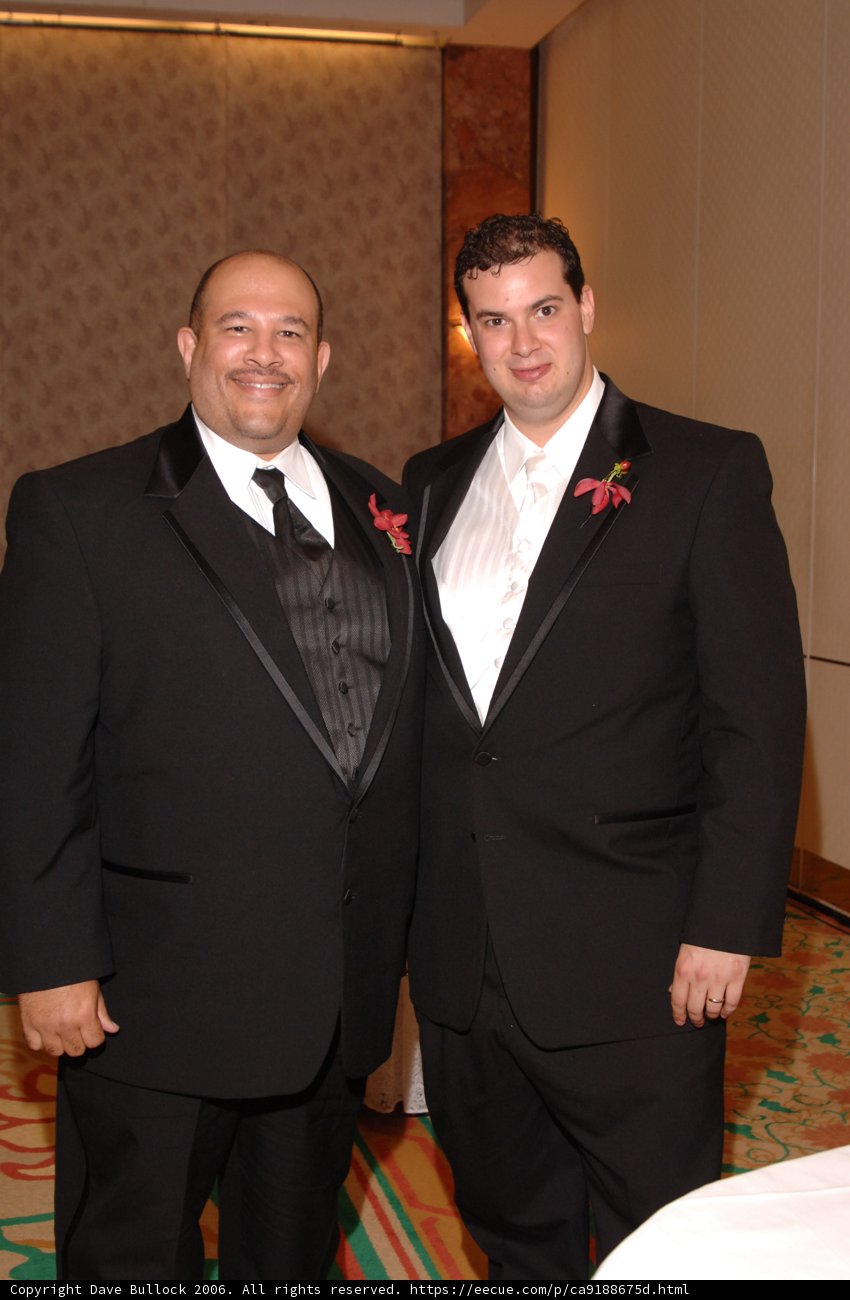 Two Men in Tuxedos Strike a Pose