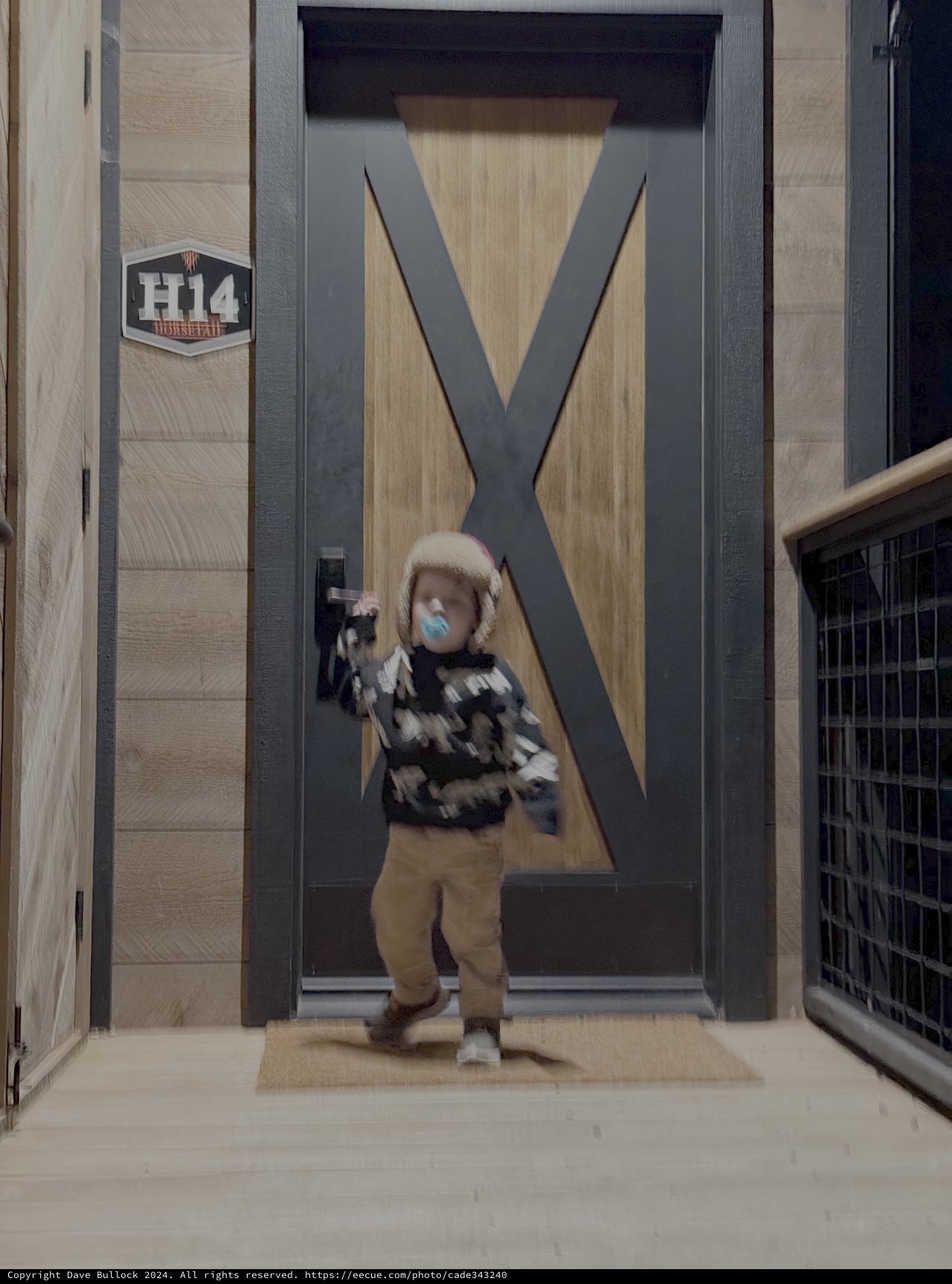 Person in Motion Blur Through Modern Building Entrance