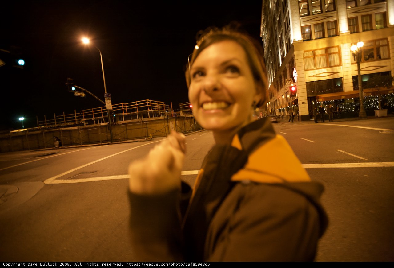 Joyful Woman Celebrates on Empty City Street at Night