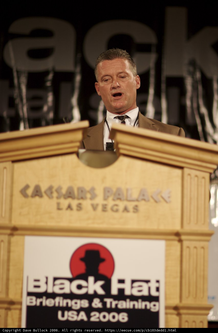 Man Speaking at Plywood Podium