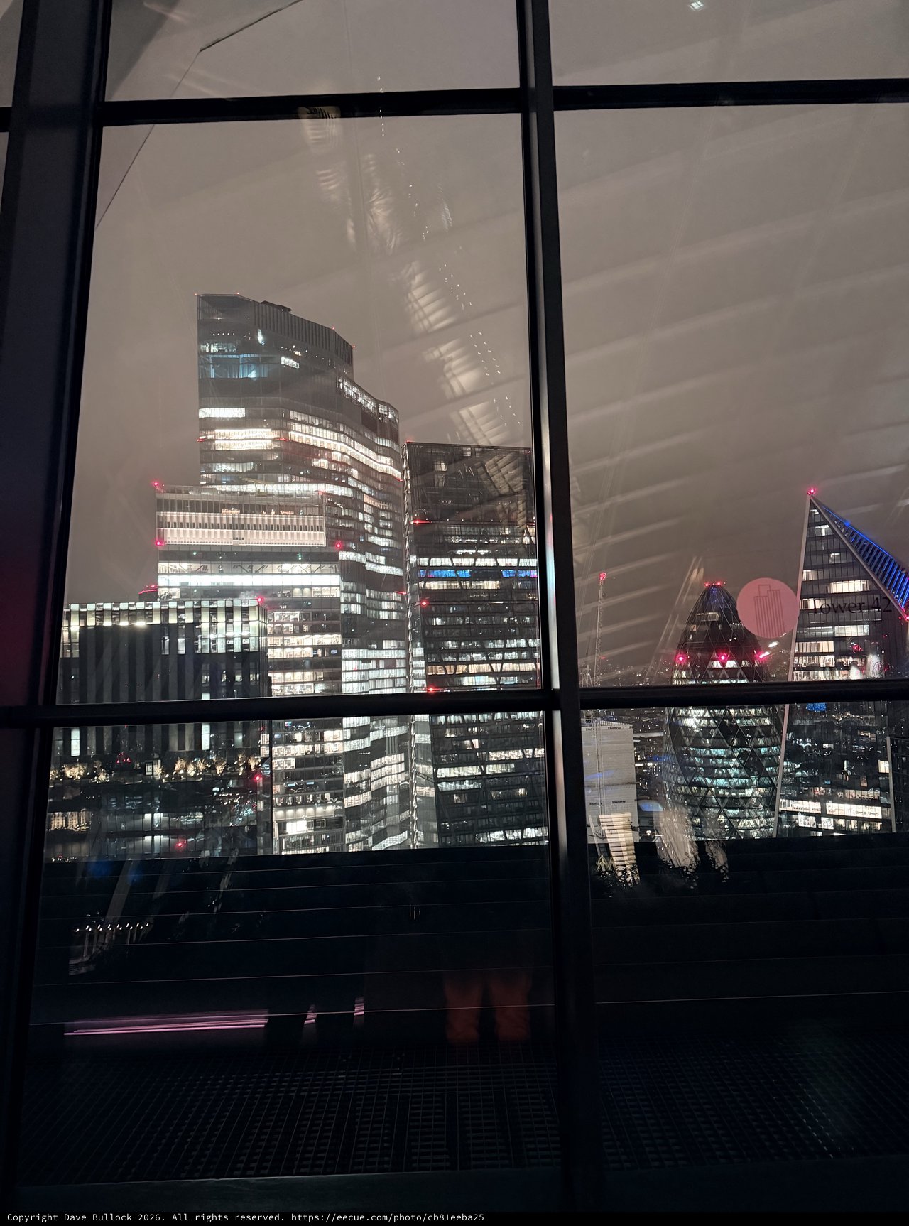 London Financial District Skyline at Night Through Window