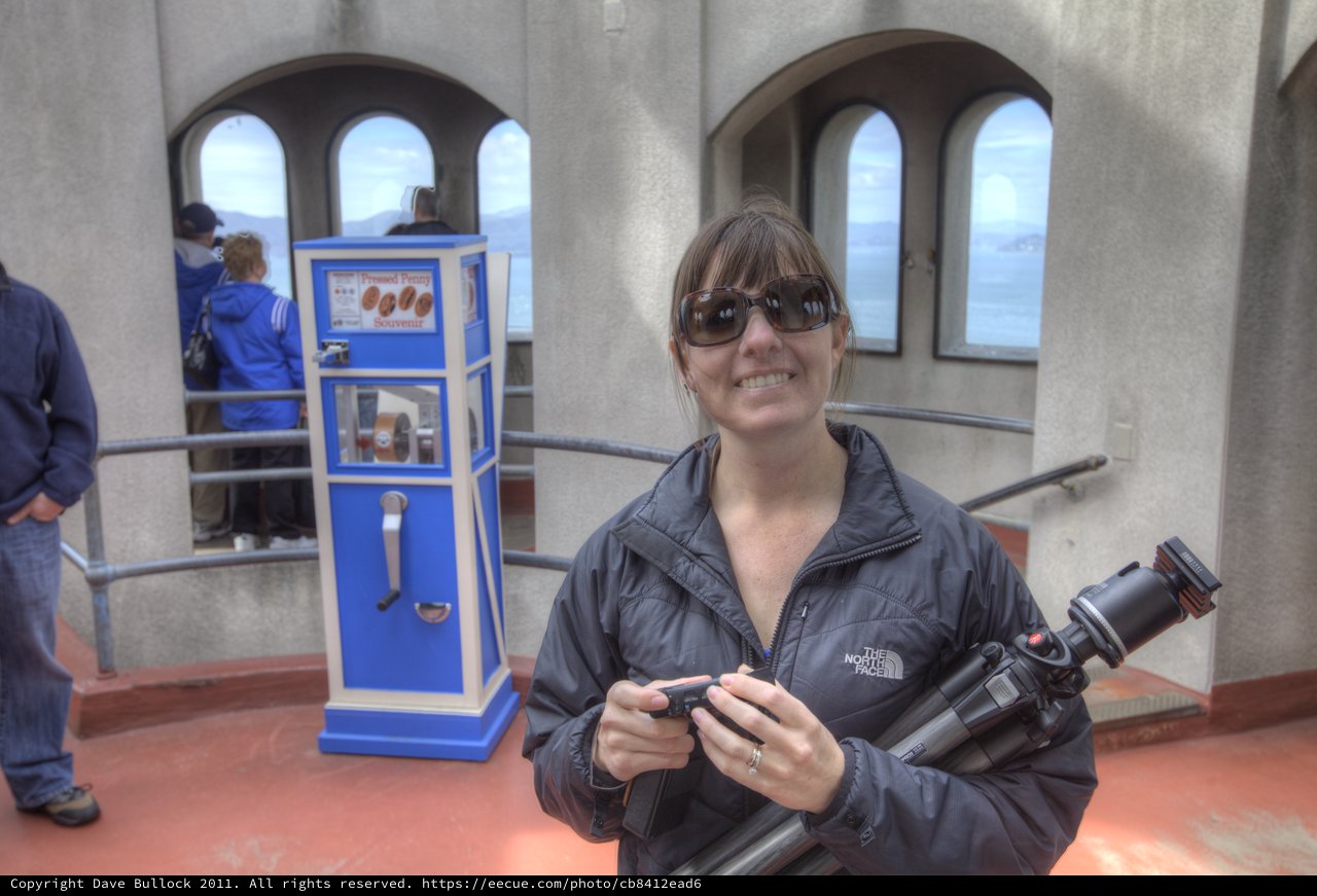 Photographer Smiling at Pressed Penny Souvenir Machine