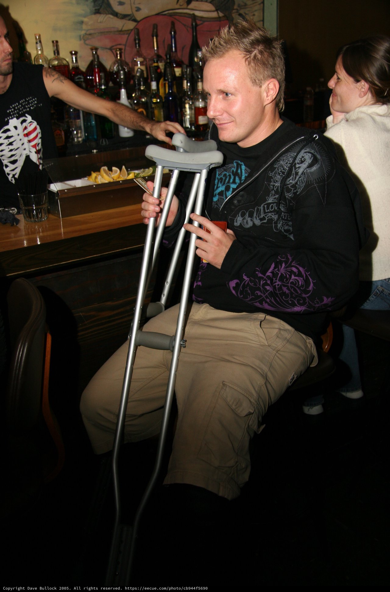 Man on Crutches Relaxing at a Bar