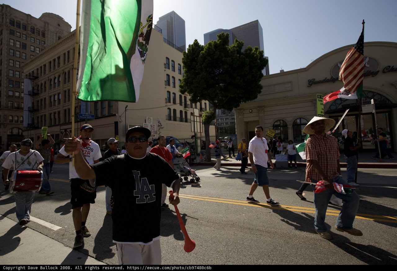 Man Marching with Flag in Mayday Rally