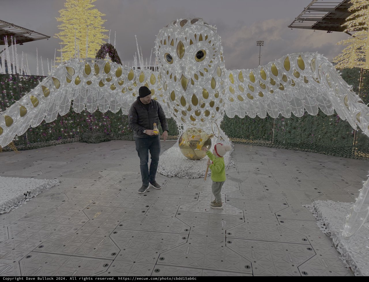 Child Playing Near Giant White Owl Sculpture