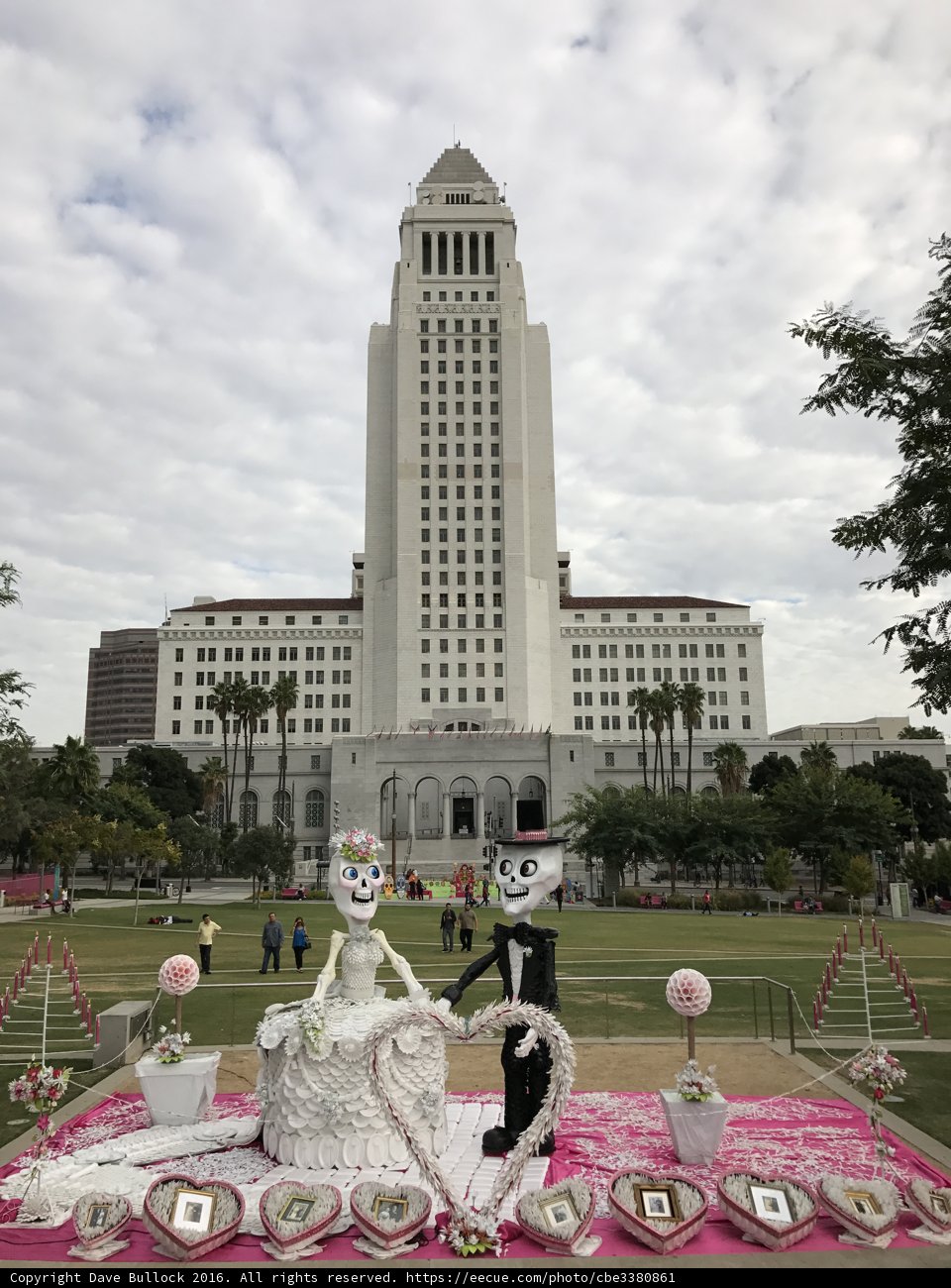 Pink Table with Skeleton in Front of City Building